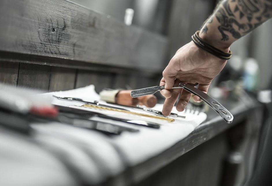 Barber Setting up Hair Cutting Tools on a Table